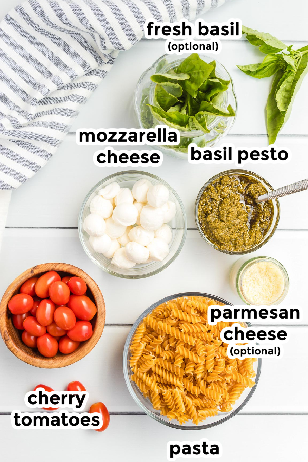 Ingredients for pesto pasta salad in bowls with text titles on top.
