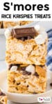 Two square S'mores Rice Krispies treats stacked on a plate, topped with Hershey's chocolate, mini marshmallows, and chocolate chips with title text at the top of the image.