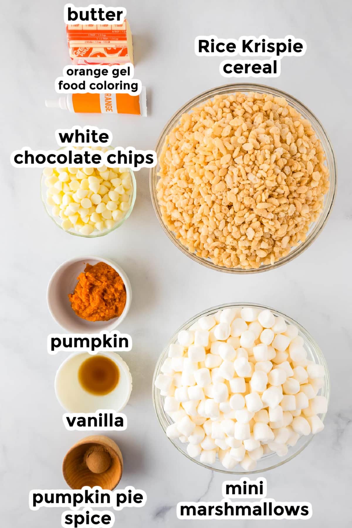 Ingredients for pumpkin spice Rice Krispie treats in bowls on a counter with text labels.