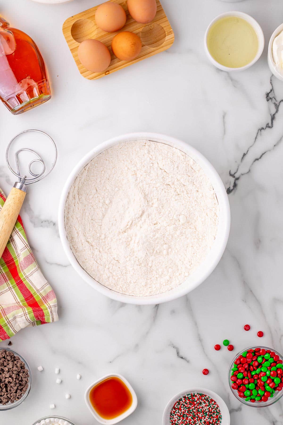 A bowl of cake mix and other dry ingredients for elf cupcakes being mixed together.