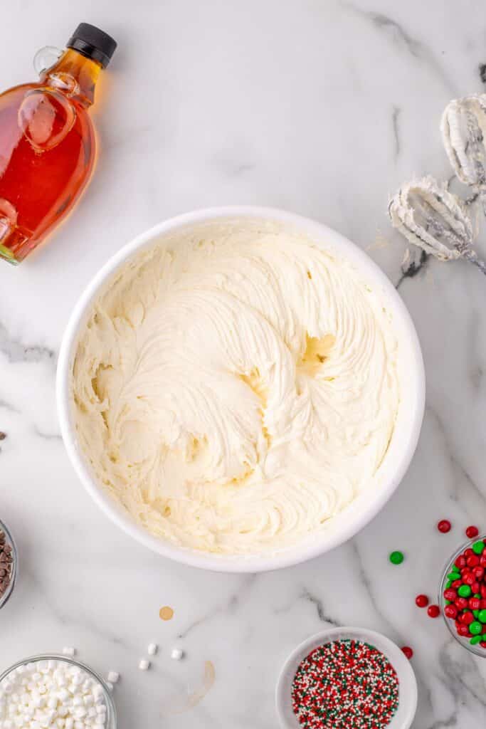 A bowl of creamy white frosting after being mixed together for elf cupcakes.