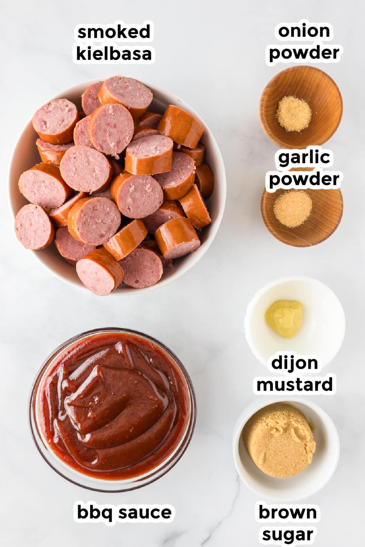 Ingredients for crock pot bbq smoked kielbasa in bowls on a counter with text labels.