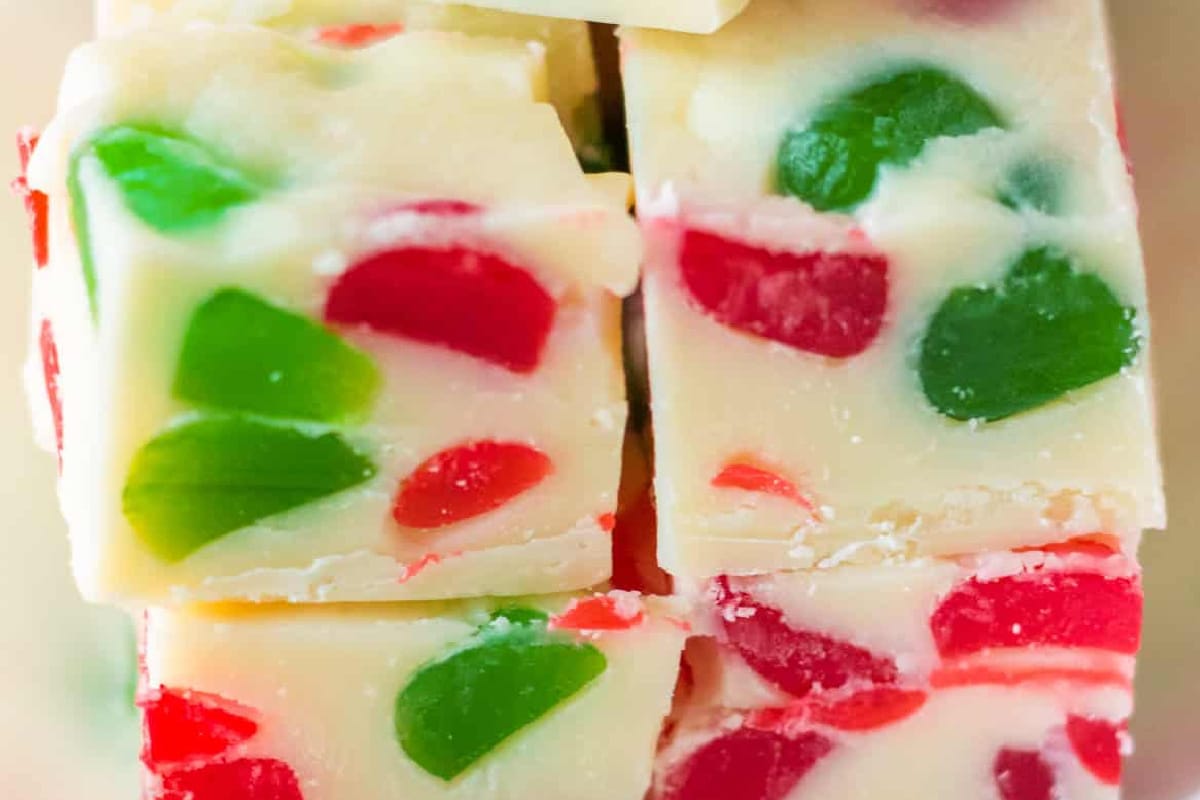 Close-up of white fudge pieces full of red and green gumdrops.