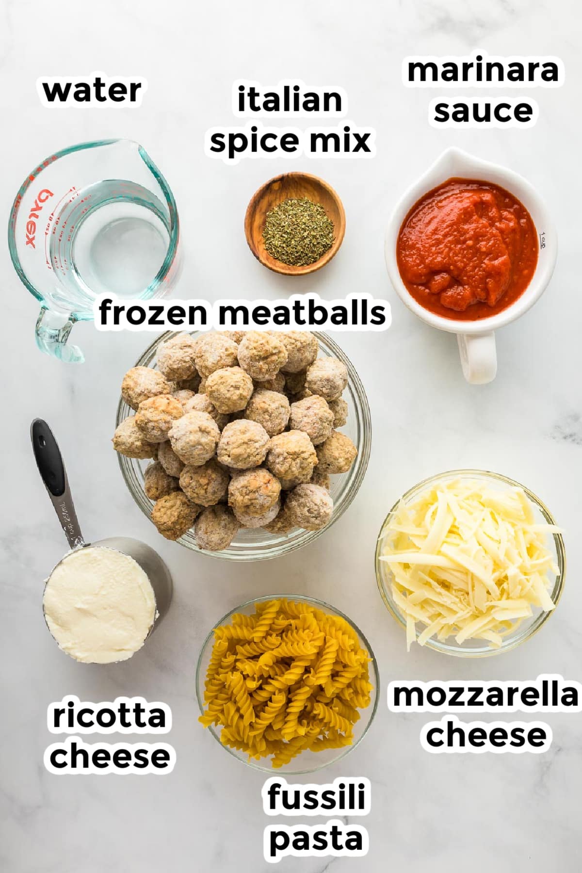 Ingredients for a dump and bake meatball casserole in bowls on a counter with text labels.