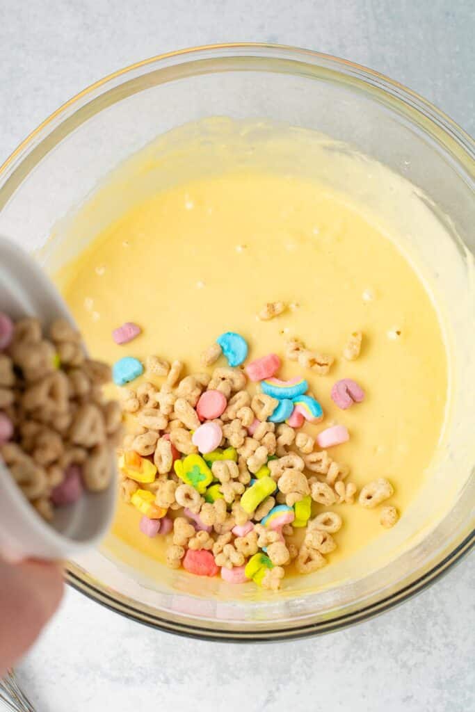 Lucky Charms cereal being mixed into pancake batter.