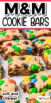 Close-up of M&M cookie bars on a tray after slicing with title text across the top of the image.