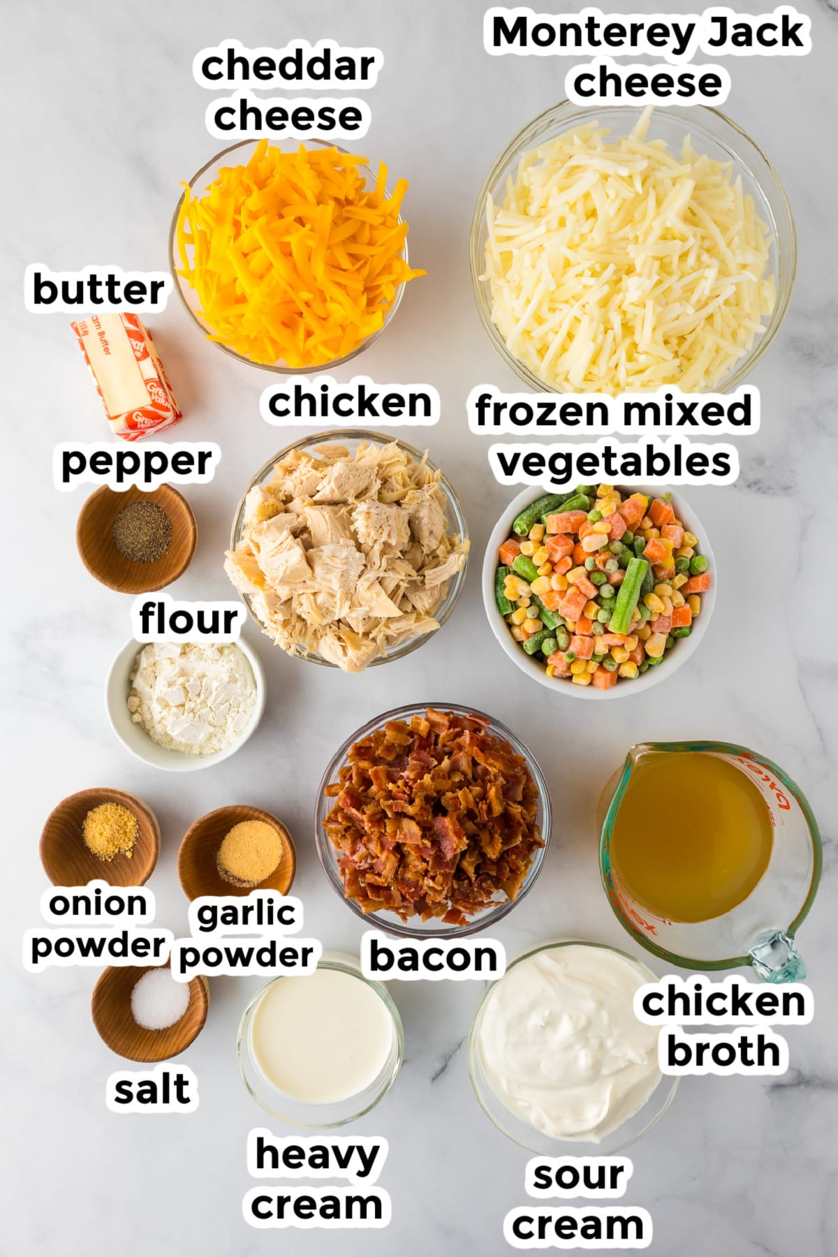 Ingredients for a creamy chicken hashbrown casserole on a counter in bowls with title text labels.