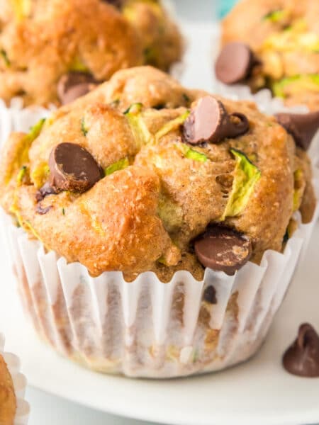 Side view of a chocolate chip zucchini muffin close up on a plate.