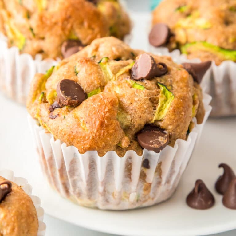 Side view of a chocolate chip zucchini muffin close up on a plate.