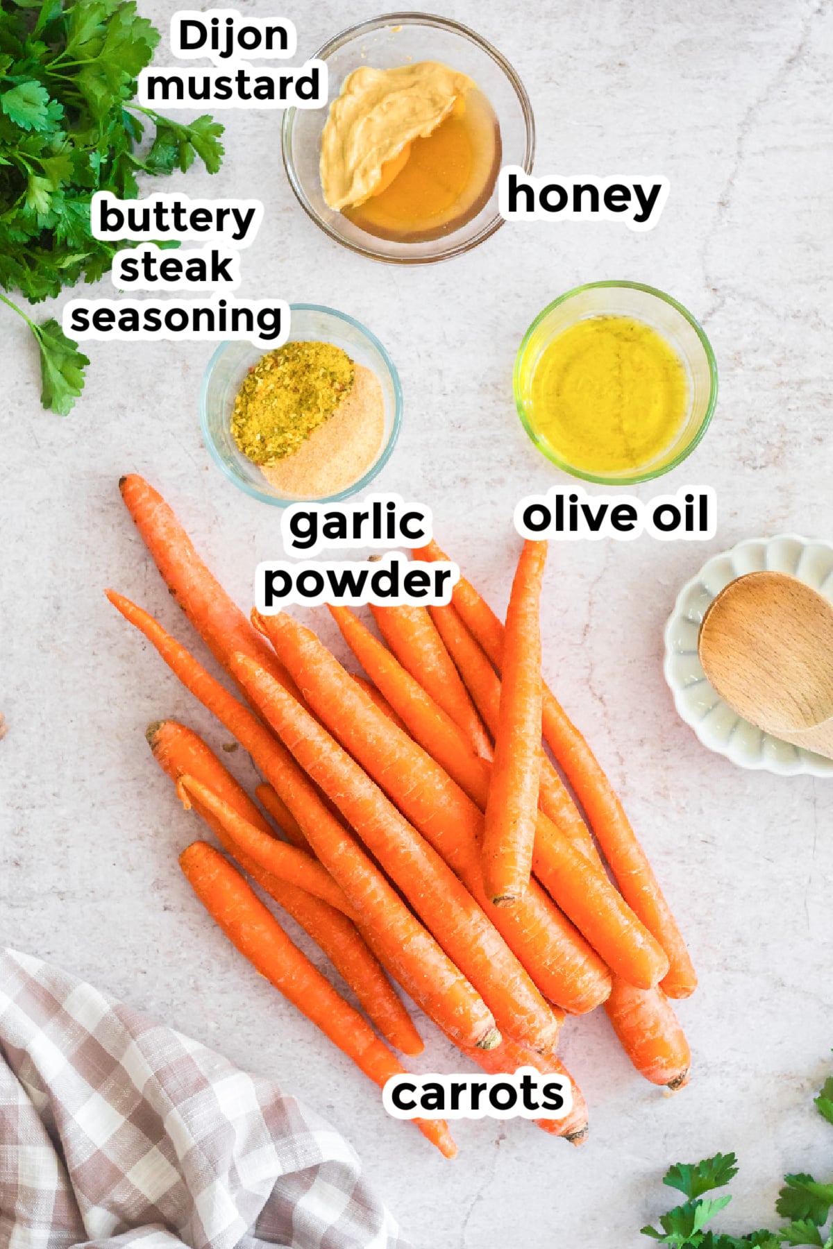 Ingredients for glazed honey mustard carrots on a counter with text labels.