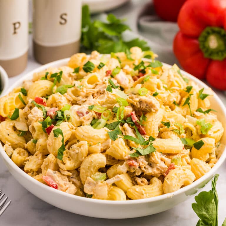 Square verison of a white bowl filled with creamy chicken macaroni pasta salad.