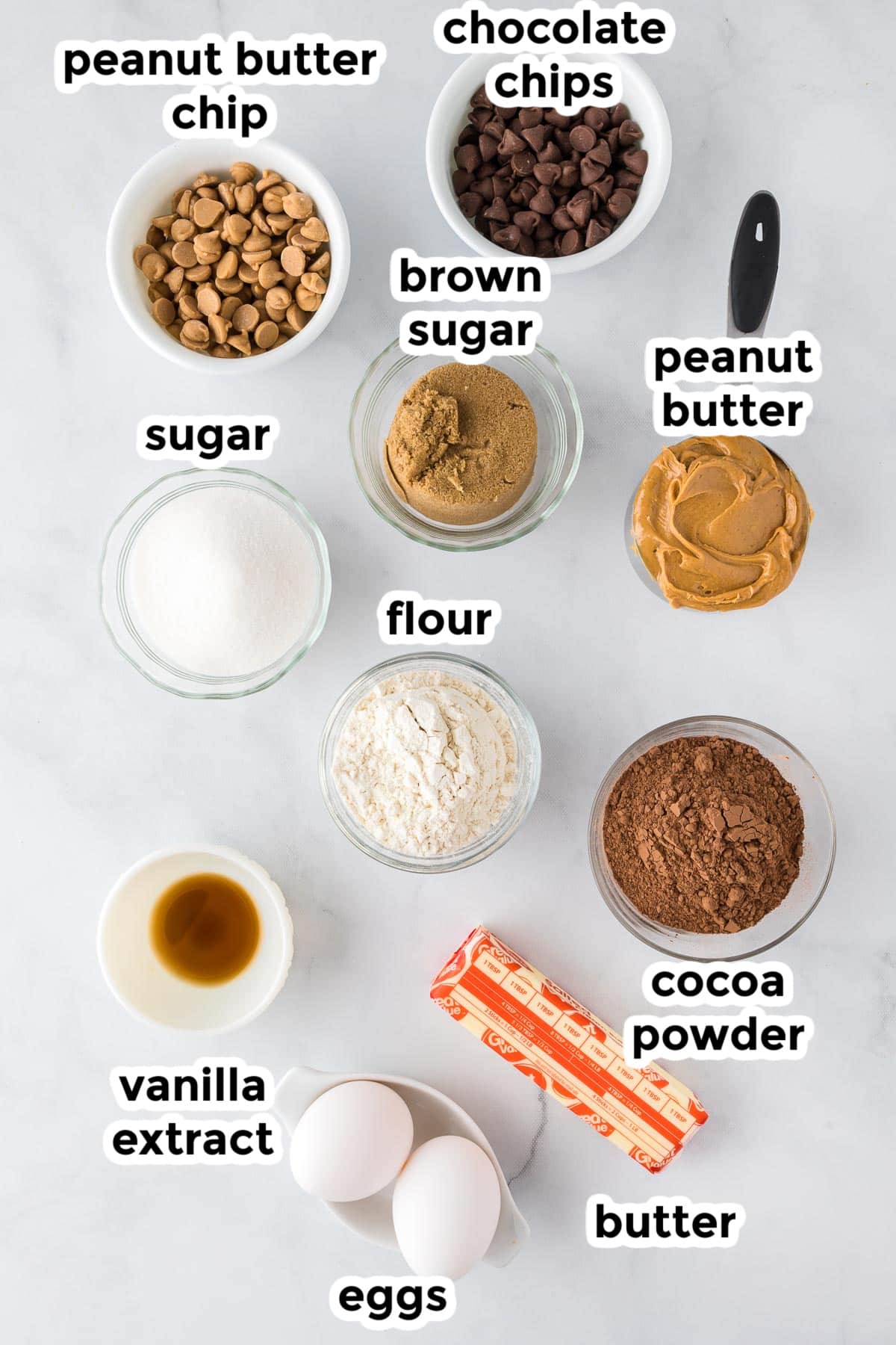 Ingredients for peanut butter swirled brownies on a counter with text labels.