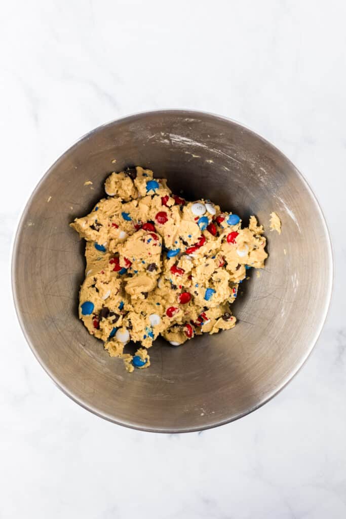 A bowl of cookie dough for Red White And Blue M&M cookies after mixing.