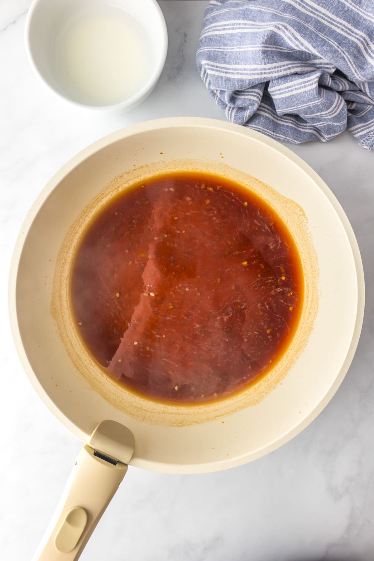 A pan full of teriyaki sauce thickening for ground turkey teriyaki.