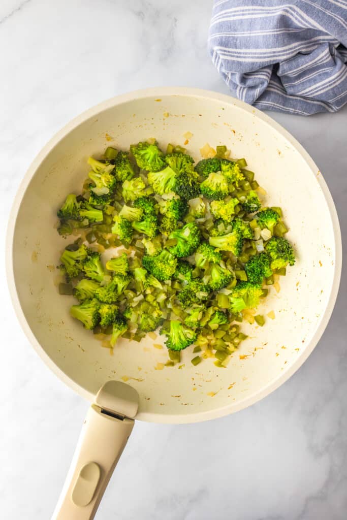 Cooked broccoli, pepper and onion in a pan for ground turkey teriyaki.