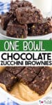 A plate of chocolate zucchini brownies is stacked, with more brownies in a parchment-lined baking pan below.
