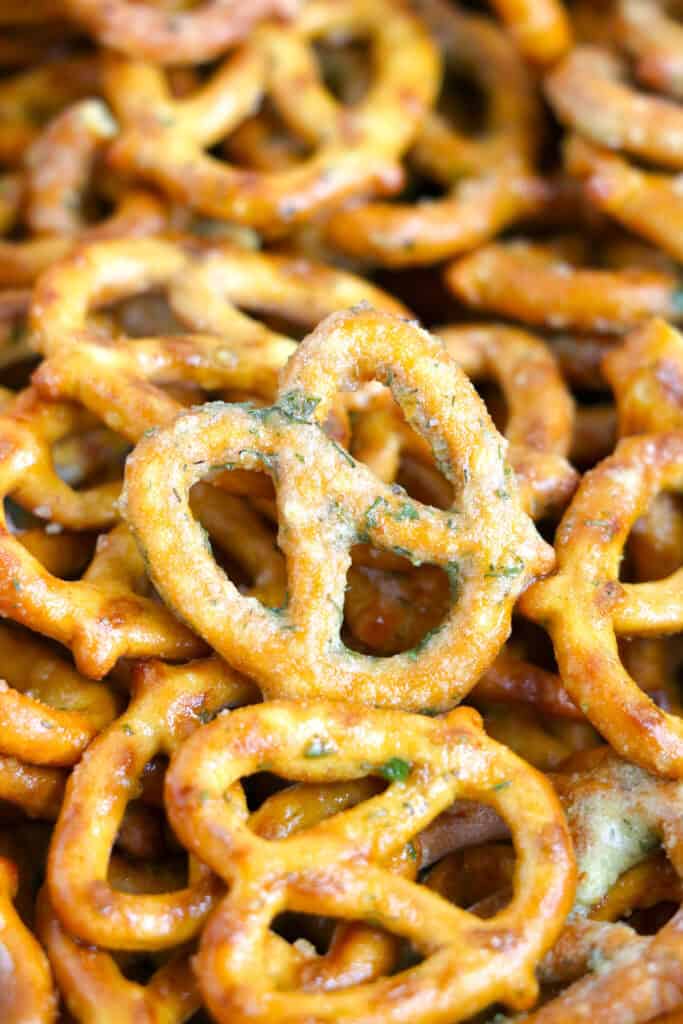 Close-up of a pile of garlic ranch pretzels, with one pretzel prominently in focus on top of the others.