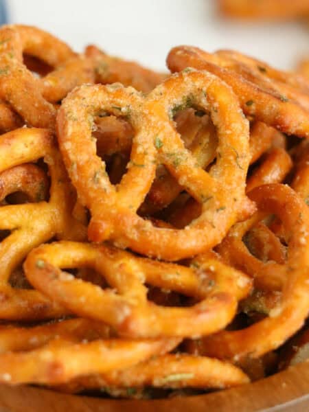 A close-up of a bowl filled with crunchy, seasoned ranch pretzels.