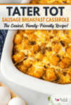 A tater tot breakfast casserole with sausage, baked to perfection and topped with melted cheese in a white dish, surrounded by whole eggs and a checkered napkin.