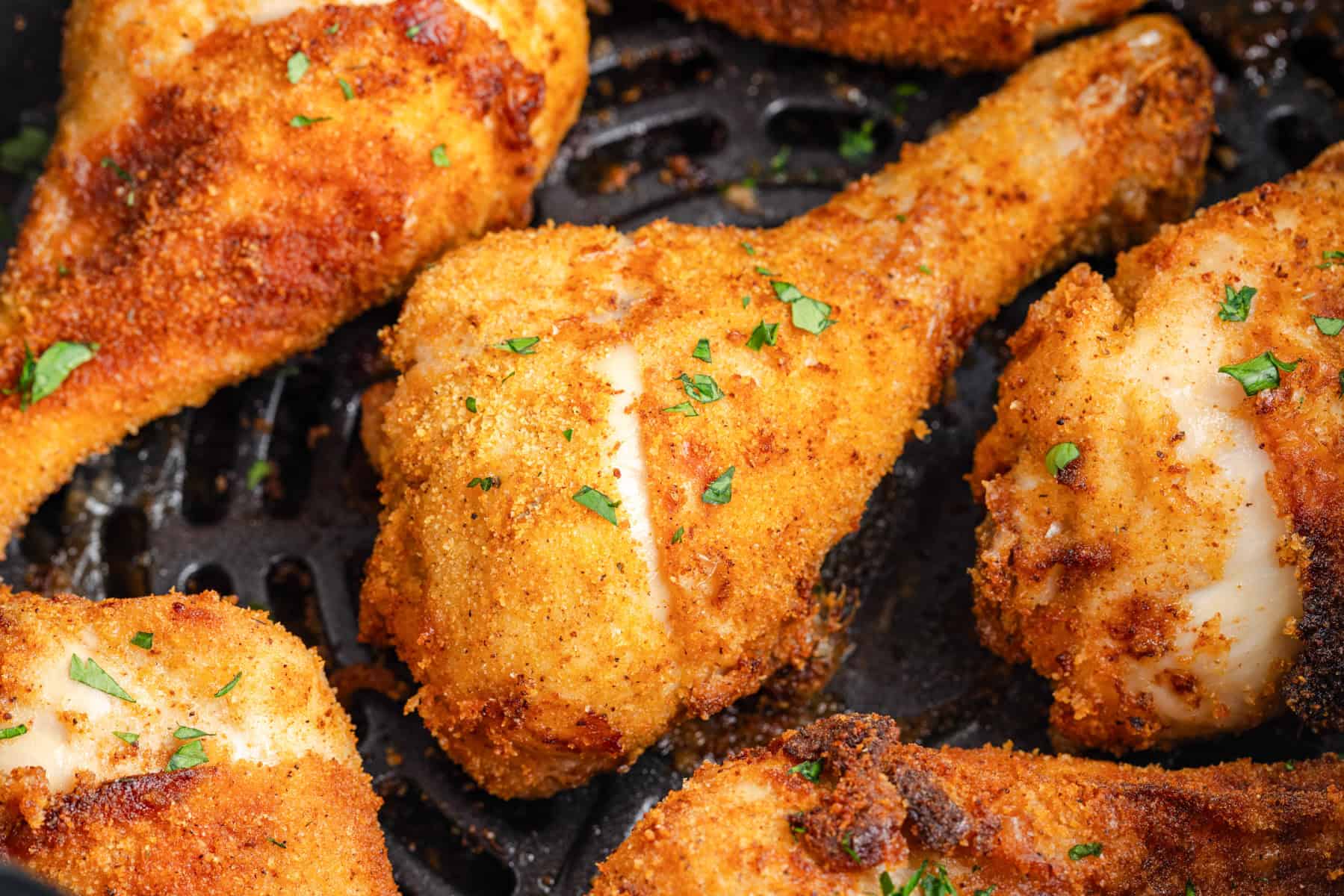 Close-up of shake and bake air fryer chicken drumsticks, breaded and crispy.