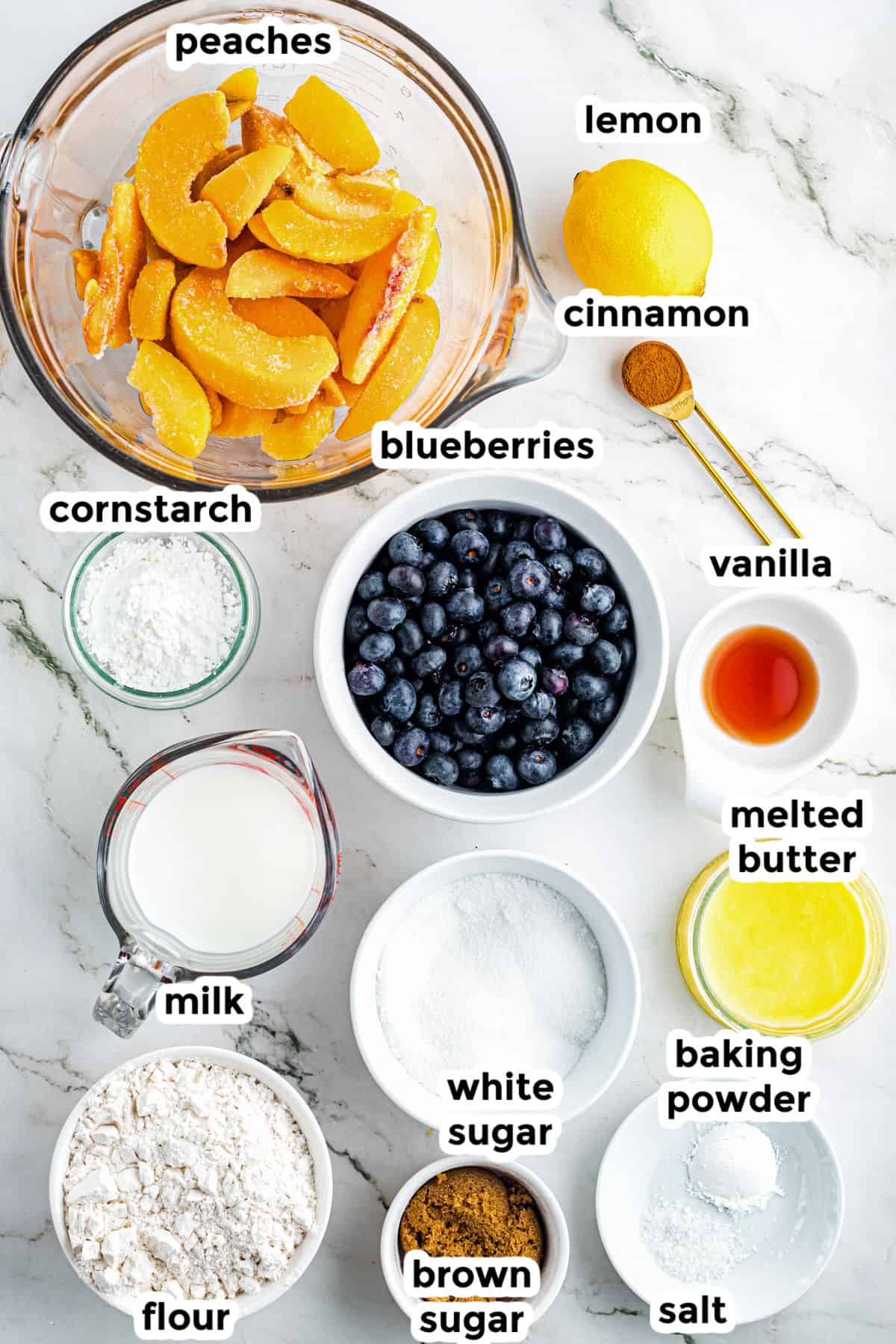 Top-down view of labeled ingredients peach blueberry cobbler.