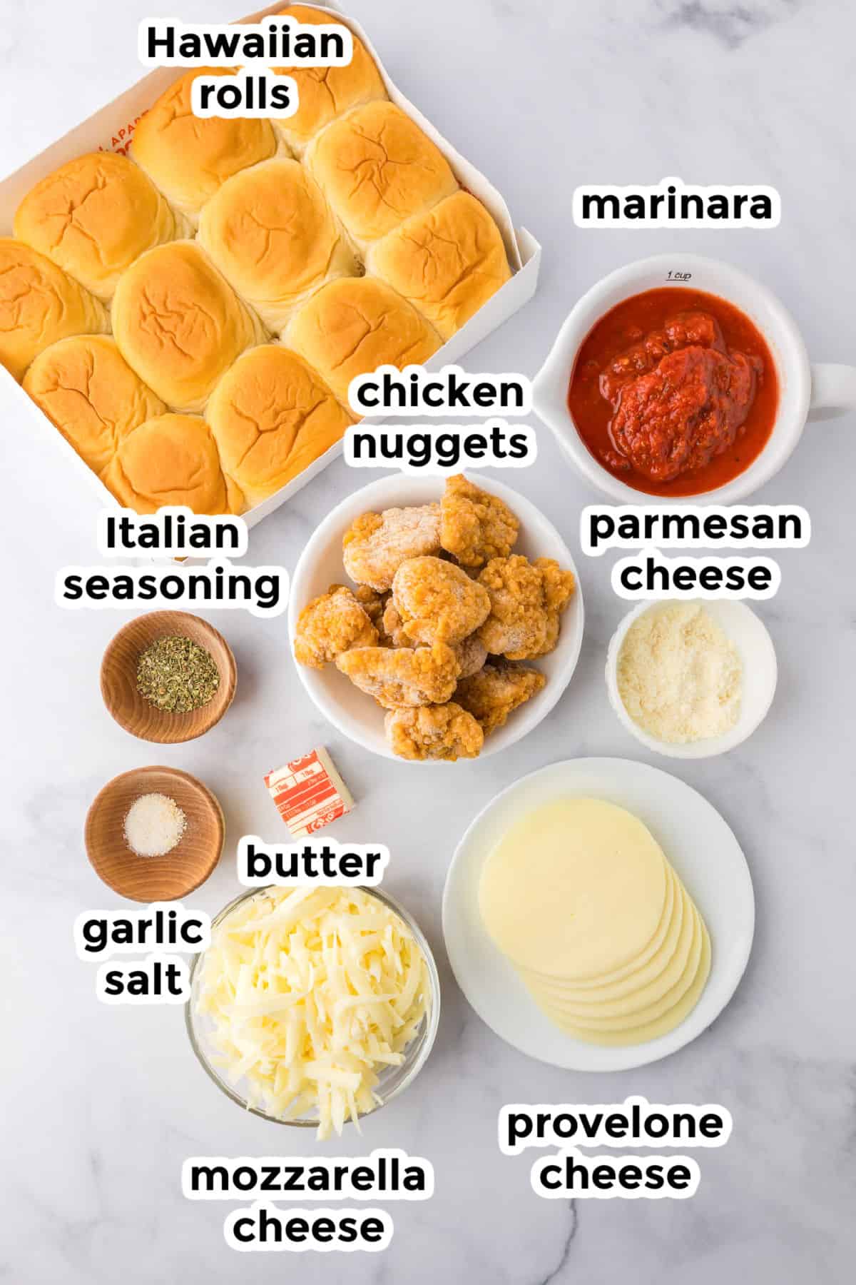 Ingredients for chicken parmesan sliders on a counter with text labels.