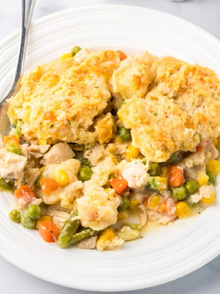 Chicken cheddar bay biscuit pot pie served on a white plate with a fork.