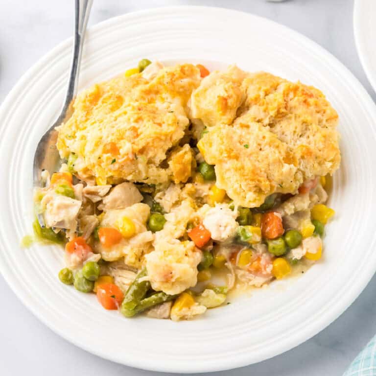 Chicken cheddar bay biscuit pot pie served on a white plate with a fork.